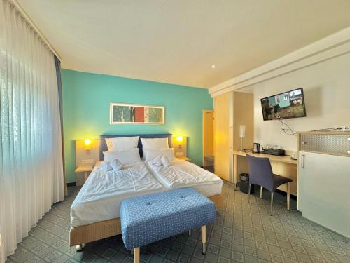a hotel room with a bed and a desk at AR Boutique Hotel Mannheim in Mannheim