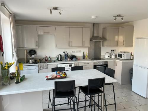 a kitchen with a table and chairs in it at Large triple room in Canada Water London in London
