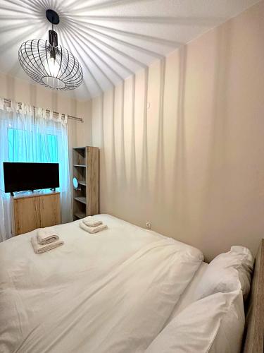 a white bed in a room with a window at Nidus 101 in Souda