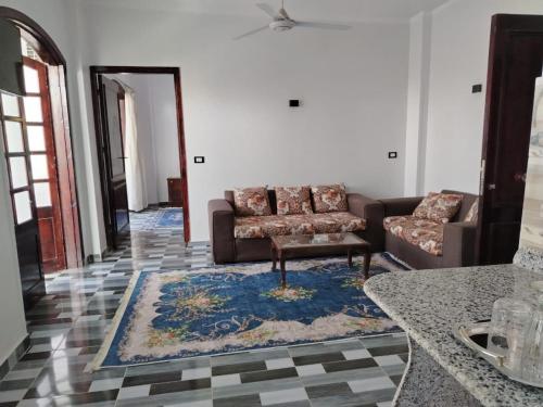 a living room with a couch and a rug at Mena Palace Nile View in Luxor