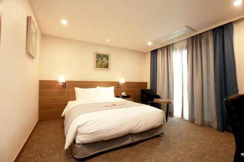 Postel nebo postele na pokoji v ubytování Ramada Taebaek Hotel