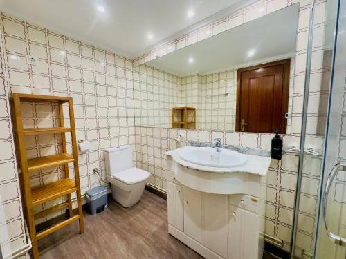 a bathroom with a sink and a toilet at Piso en Lekeitio, Costa Vasca, Bizkaia. in Lekeitio