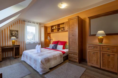 a bedroom with a bed and a tv in it at City Apartman Eger in Eger