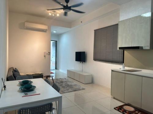 a kitchen and living room with a ceiling fan at Paradigm Residence by YML Home in Johor Bahru