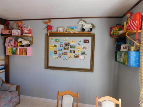 a wall with a bulletin board with a picture on it at Vandrarhem Solgården in Blackstad