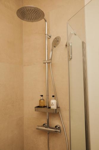 a shower with a shower head in a bathroom at A Place Antwerp - Boutique Suites & Flats - Oude Koornmarkt 1 in Antwerp