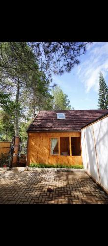 a small house with a brick driveway in front of it at Kala Cabin Classic in Bongkor 1