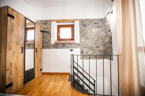 a hallway with a door and a stair case at Casa Mina in Carate Urio