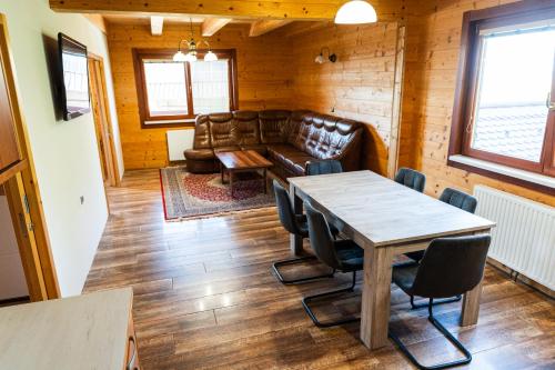 a living room with a table and a couch at Adventure Farm in Štore
