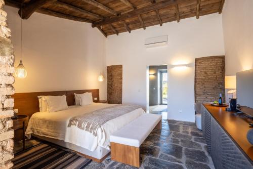 a bedroom with a bed and a desk at Land of Alandroal in Alandroal