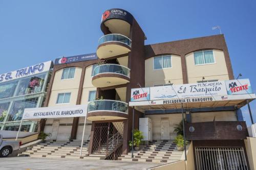 a building with balconies on the side of it at Capital O Hotel Los Caracoles, Acapulco in Acapulco