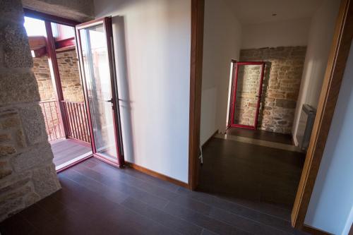 an empty room with a door and a balcony at Casa Mirandês Rural in Miranda do Douro