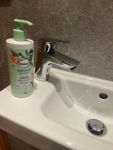 a bathroom sink with a bottle of toothpaste on it at Appartement Berghof "Dettis Place" in Gerlos