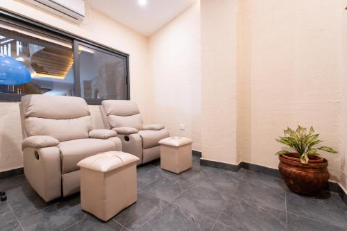 a waiting room with two chairs and a plant at Temple Bell Boutique Hotel & Spa in Pokhara