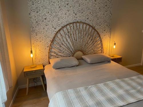 a bedroom with a large bed with two pillows on it at Logement cosy au cœur de Nevers in Nevers