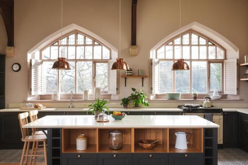 a kitchen with two windows and a white counter top at Wesleyan Bolton Abbey Estate in Appletreewick