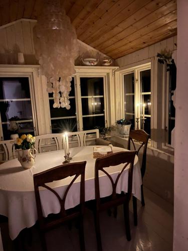 a dining room with a table with a candle on it at Hyggeligt hus in Lilla Stockhult