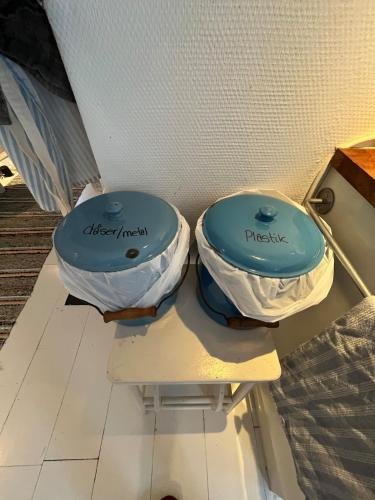 two toilets sitting next to each other on a shelf at Hyggeligt hus in Lilla Stockhult
