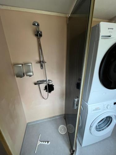 a washer and dryer in a small room at Hyggeligt hus in Lilla Stockhult