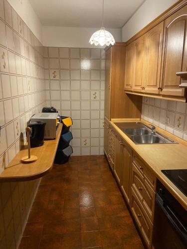 a kitchen with a sink and a counter top at Appartamento Netta'Schtol in Sappada