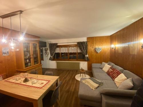 a living room with a couch and a table at Appartamento Netta'Schtol in Sappada