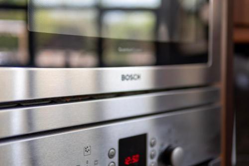 two stainless steel microwaves sitting next to each other at Abbey Farm House - Pet Friendly in Ormskirk