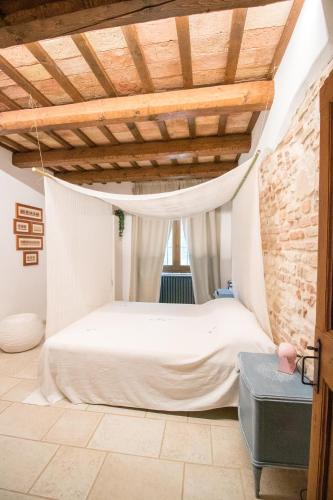 a bedroom with a bed and a wooden ceiling at Villa Altrove in Montemarciano