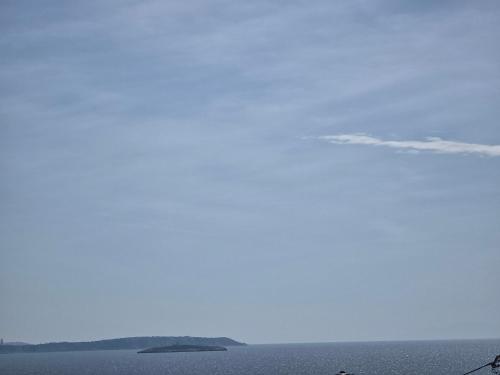 a large body of water with an island in the distance at GLIPTIS Apartments in Karfas
