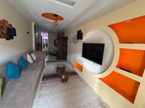 a living room with a couch and a tv on a wall at Hurghada Sea View Apartment in Hurghada