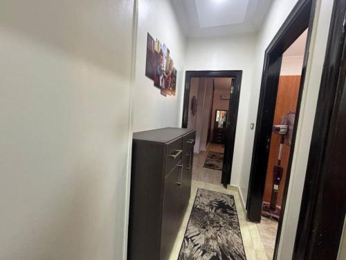 a hallway with a black refrigerator in a room at Hurghada Sea View Apartment in Hurghada