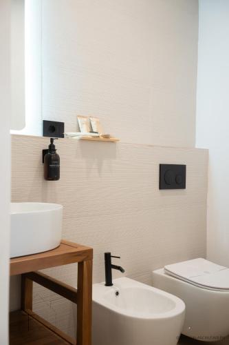 a bathroom with a sink and a toilet at Turchetti's Rooms in Porto Ercole