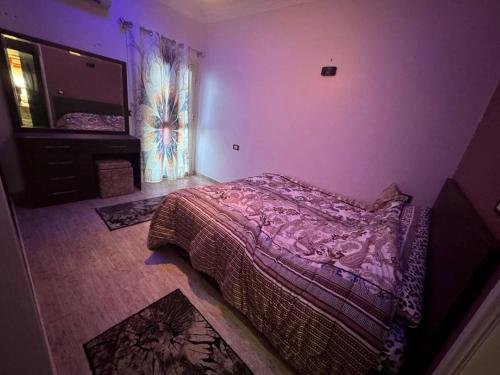 a bedroom with a bed and a mirror on the wall at Hurghada Sea View Apartment in Hurghada