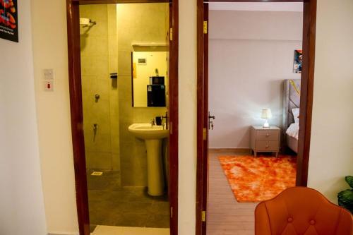 a bathroom with a sink and a toilet in a room at 1 Bedroom Apartment in Syokimau near Airport and SGR in Nairobi