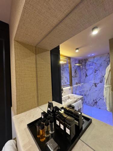 a bathroom with a large mirror and a sink at Pantheon Suite - Residenze di Charme in Rome