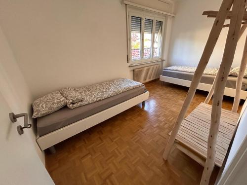a bedroom with two bunk beds and a window at Corte del Pino in Losone