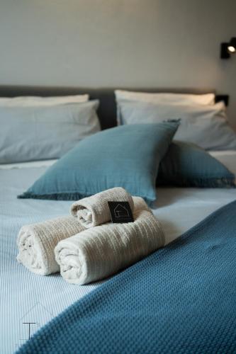 a pair of towels sitting on top of a bed at Turchetti's Rooms in Porto Ercole