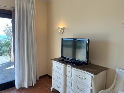 a flat screen tv sitting on top of a dresser at Villa Camilla-Stintino, Sardegna in Sassari