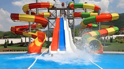 a water park with a water slide in a pool at OPERA LUX APARTMENTS - Green Hill kompleks Sokobanja & Free Parking - kod Akva Parka in Soko Banja