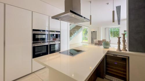 a kitchen with white cabinets and a counter top at Vivo Mare Beachfront Villas - Vista in Ayia Napa