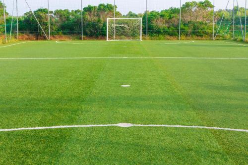 an empty soccer field with a goal at Grande Baia Resort & Spa in San Teodoro