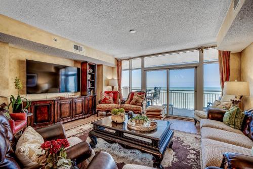 a living room with a couch and a tv at Ocean Blue 902 in Myrtle Beach