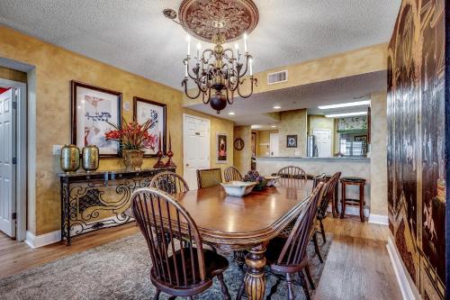 a dining room with a wooden table and chairs at Ocean Blue 902 in Myrtle Beach