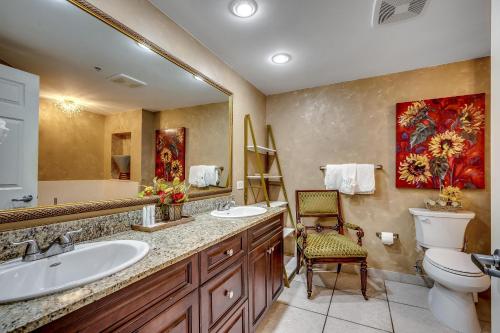 a bathroom with a sink and a toilet and a mirror at Ocean Blue 902 in Myrtle Beach