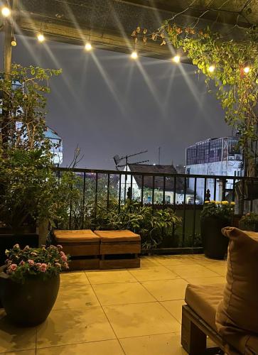 a patio with benches and potted plants and lights at HiHome Bellevie Lakeview Escape in Hanoi OldQuarter in Hanoi
