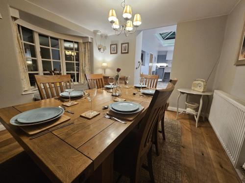 a dining room with a wooden table and chairs at Holly Cottage in Hutton le Hole
