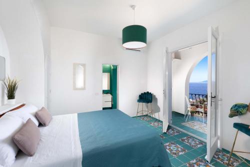 a bedroom with a bed and a view of the ocean at Estate4home - Suite Bonview in Massa Lubrense