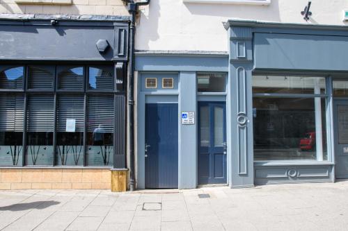 a store front with a blue door and windows at Suite 2- 2 Bed Apartment in Lincoln