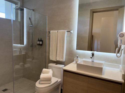 a bathroom with a toilet and a sink and a shower at AmazINN Places Playa Escondida in María Chiquita