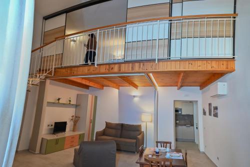 a person standing on a staircase in a living room at La Dimora di Nonna Maria in Maiori