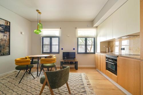 a kitchen with a table and chairs in a room at Baía Terraza Cascais Apartment in Cascais